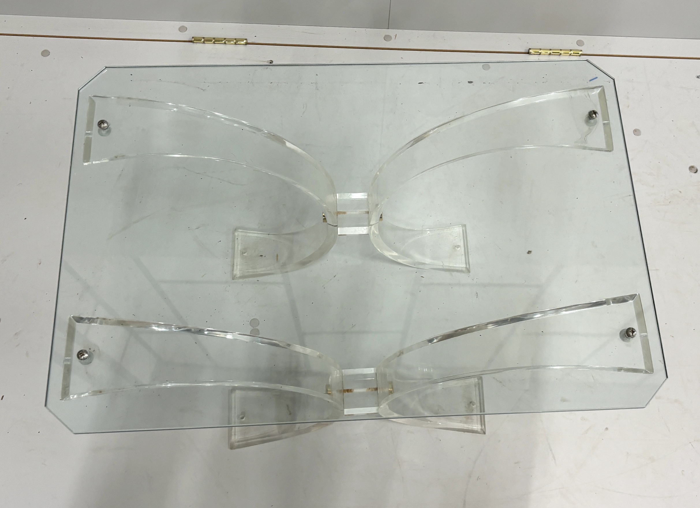 A perspex and glass coffee table, width 69cm, depth 46cm, height 47cm